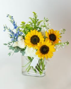 a vase filled with yellow and white flowers