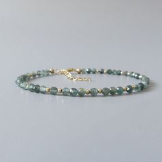 Fall in love with our dainty and rare genuine teal green kyanite gemstone beaded bracelet. Your purchase will arrive elegantly packed  in a gift-ready suede storage bag  and will include a complimentary cleaning cloth. Treat yourself or your loved ones with this high-quality handmade jewelry gift.  D E T A I L S -Genuine rare teal green kyanite faceted beads -Bead size 3mm, the bracelet appears larger in photos  -With scattered sterling silver, rose gold filled, or 14k gold filled accent beads - Beaded Gemstone Bracelets, Dainty Gemstone Jewelry, Kyanite Bracelet, Birthday Gift Mom, Green Kyanite, Green Beaded Bracelets, Beaded Jewlery, Diy Bracelet Designs, Diy Bracelets Patterns