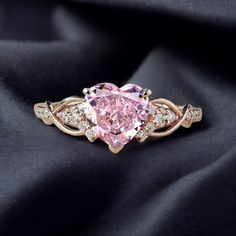 Heart Shape Pink Sapphire Engagement Ring 14k Rose Gold Promise Ring Elegant Usagi Bridal Wedding Jewelry Diamond Halo Proposal Gift For Her Welcome to Shreenathjewelry JUST OPENED- Experience beautiful jewelry that complements your everyday style, and completes your look. Our jewelry is so stunning, and so you are. Ring description Primary Stone:- Pink Sapphire  (Lab Created) Stone Shape:- Heart Stone Size:- 7 MM Stone Color:- Pink Second Stone: CZ Diamond  Stone Color: Colorless Stone Shape: Round Jewelry Type: Stacking Ring Method: Cast Personalization: Possible Occasion: Engagement Ring Size: We make rings from US 4 to US 10. (If you need smaller or bigger ring size, please ask me to resize) Country of Manufacture: India All our work is custom made by hand with Love and Care in our wor Unique Pink Engagement Rings, Pink Sapphire Engagement Ring Rose Gold, Sapphire Engagement Ring Rose Gold, Cluster Wedding Ring, Pink Sapphire Engagement Ring, Pink Diamonds Engagement, Heart Shaped Diamond Ring, Pink Stone Rings, Rose Gold Promise Ring