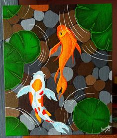 two orange and white koi fish swimming in the water with green leaves around them