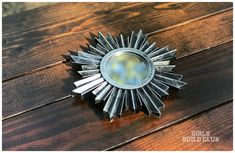 a metal sunburst sitting on top of a wooden table