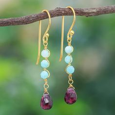 Deep scarlet and icy blue mingle in these graceful dangle earrings designed by Thailand's Somsiri Juntamin. The artisan wraps three amazonite gemstones in undulating 24k gold-plated sterling silver wires while a faceted garnet dangles gracefully below. Gold Plated Dangle Jewelry With Gemstone Accents, Elegant Garnet Briolette Earrings, Handmade Dangle Amazonite Earrings, Faceted Garnet Drop Earrings, Gold Multi-stone Dangle Gemstones, Gold River, Earrings Summer, Icy Blue, Cookies Decorated