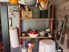 the kitchen is organized and ready for us to use it's shelves are full of utensils