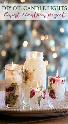 candles are sitting in glass jars on a tray with lights behind them and the words diy oil candle lights easy christmas project