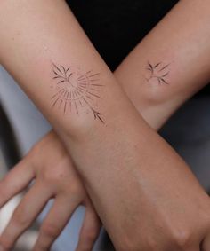 two people with matching tattoos on their arms