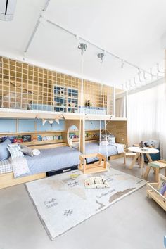 a child's bedroom with bunk beds, desks and other furniture in it