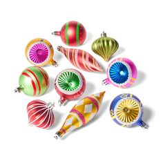 an assortment of colorful christmas ornaments on a white background with clippings to the side