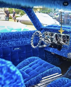 the interior of an old car with blue velvet upholstered and chromed trim