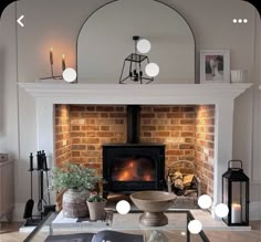 a living room filled with furniture and a fire place in the middle of it's fireplace