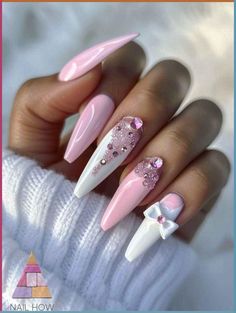 Elevate your nail game with these stunning stiletto nails featuring a sweet pastel pink base, delicate white accents, and a touch of sparkling embellishments. Adorned with a 3D bow and glittering gems, this design is a perfect blend of elegance and playfulness. Head to NailHow.com for more inspiring ideas and nail art essentials! Princess Nail Designs, Uñas Coquette, Nails Girly, Plaid Nail Designs, Soft Pink Nails, Coquette Nails