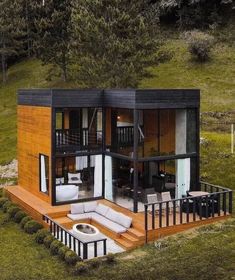 an aerial view of a small house in the middle of a grassy area with stairs leading up to it