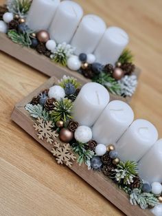 two wooden trays with candles and ornaments on them sitting on top of a table