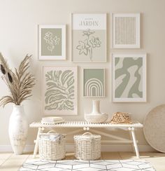 a white table topped with vases filled with flowers next to pictures on the wall