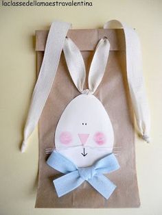 a paper bag with a bunny face on it and a bow tie around the neck