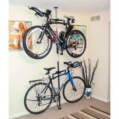 two bikes are mounted to the wall in this room