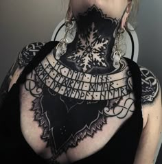 a woman with tattoos on her neck and chest