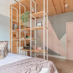 a room with a bed and shelves on the wall next to each other in it