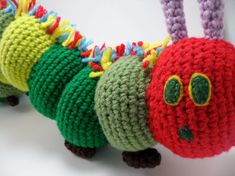 a crocheted caterpillar is sitting on the table