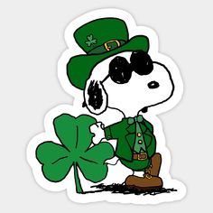 a sticker with a dog in a green hat and glasses holding a four leaf clover