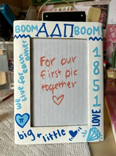 a white frame with writing on it that says, for our first pic together big little love