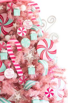 a pink christmas tree decorated with candy canes and candies