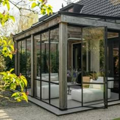 a glass house sitting on top of a lush green field