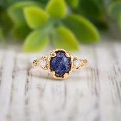 ✨ Current processing time is 4 weeks ✨     Introducing our Blue Sapphire and Diamond Engagement Ring ~ uniquely hand-carved in wax and cast in Solid 18k Gold, this nature-inspired rustic textured ring showcases a stunning blue Sapphire and 2 small conflict-free raw diamonds ~ making this a one of a kind engagement ring, or a unique gift for that very special person in your life T H E ∙ S M A L L ∙  D E T A I L S * Oval faceted natural Blue Sapphire (8-10mm) * two small silver/white raw diamonds Uncut Diamond Ring Engagement, Textured Gold Ring, Sapphire And Diamond Engagement Ring, Raw Diamond Engagement Rings, Nature Inspired Rings, Textured Ring, Alternative Engagement Rings, Uncut Diamond, Raw Diamond