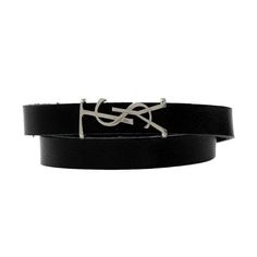 Styled with the signature silver YSL logo this wrap bracelet is a must-have! This Saint Laurent's monogram wrap bracelet is crafted of smooth black leather and features a silver magnetic box clasp closure. The silver-tone hardware creates a bracelet that will easily elevate your accessory game and is wearable beyond seasons. Model Number: 64655 Black Leather Silver-tone hardware YSL logo detail Magnetic box clasp closure Authenticity cards and box included Made in Italy Size: one size.  Color: M Designer Adjustable Leather Bracelet, Modern Formal Bracelets With Logo Charm, Modern Formal Bracelet With Logo Charm, Designer Black Leather Bracelet, Designer Adjustable Black Bracelets, Black Adjustable Designer Bracelets, Yves Saint Laurent Designer, Resin Bracelet, Ysl Logo