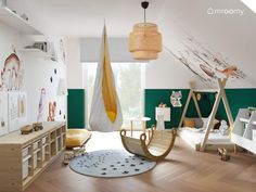 a child's room decorated in green and white with wooden flooring, rocking chair, toy swing set and wall hangings