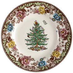 a plate with a christmas tree painted on the side and flowers all around it,