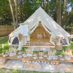 a tent set up with plates and cups