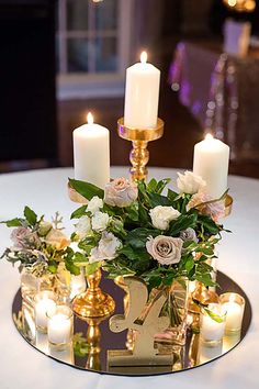 a table with candles and flowers on it