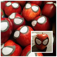 an apple has been painted to look like spiderman's eyes and is surrounded by other apples