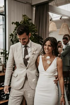 a bride and groom are walking down the aisle