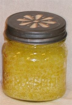 a jar filled with yellow liquid sitting on top of a table