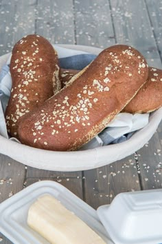 two loaves of bread in a white bowl with text overlay that reads how to make cheesecake factory brown bread