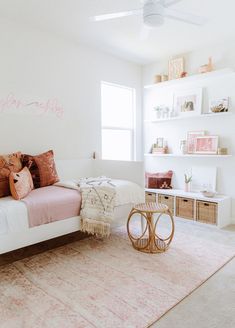 a bedroom with white walls and pink accents