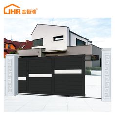 an image of a modern house with black garage doors