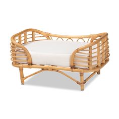 a small wooden bed with white sheets on it's sides and an arm rest