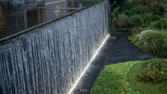 a large waterfall in the middle of a garden