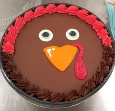 a cake decorated to look like a turkey with big eyes and a red head on top