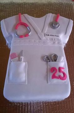 a cake shaped like a nurse's uniform with scissors and other items