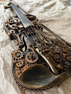 an old violin with gears and wheels on it