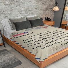 there is a bed with a poem written on the comforter in front of it