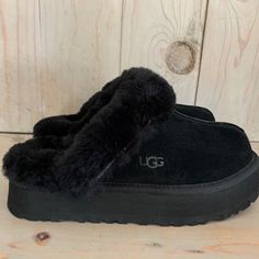 Authentic Ugg Brand New No Original Box ~Disquette ~ Merging Our Coquette And Disco Styles For A New Slipper That's Completely Unique, The Disquette Adds A 1" Retro-Style Platform Sole To A Familiar Slip-On Silhouette For Outdoor Wear, All-Day Cushion, And A Maximalist Look. Crafted From Our Signature Sheepskin And Suede, This Effortless Style Adds A Playful Statement To All Your Favorite Outfits Try Pairing With Jeans Or A Flowy Midi Dress. Suede Upper Sheepskin Collar 10mm Sheepskin Lining 10mm Sheepskin Insole Eva Outsole Textile Binding Made From 100% Recycled Polyester Fibers 1" Platform Height Woven Label With Ugg Logo On Insole, Heat-Embossed Ugg Logo All My Items Are Aut Goth Slippers, Black Ugg Slippers, Cute Uggs, Uggs Black, Silly Clothes, Disco Style, Black Clogs, Flowy Midi Dress, Comfy Slippers