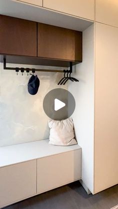 a room with some cabinets and hats hanging on the hooks in it's wall