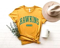 This Hawkins Indiana High School Upside Down shirt would be perfect for Sci-Fi Lover this Halloween, or to wear as a funny school shirt any time of the year! FREE SHIPPING All items are made to order and there are no returns on merchandise. Please be sure to double check your order before placement, and see sizing chart and size recommendations to find the best fit for you! The Unisex Bella + Canvas 3001 is a soft, light t-shirt with a little stretch and a flattering look for both men and women. Hawkins Middle School Shirt, Hawkins T Shirt, Sunnydale High School, North Carolina Shirt, Scary Movie Shirts, Hawkins Indiana, Logo Tv, Nana T Shirts, Outer Banks North Carolina