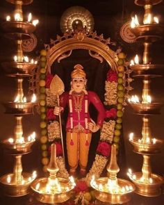 the statue is surrounded by many candles