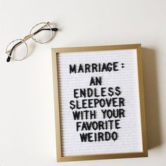 a framed sign with words written on it next to glasses and a pair of eyeglasses