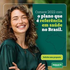 a woman smiling with her arms crossed in front of an advertisement for the spanish language